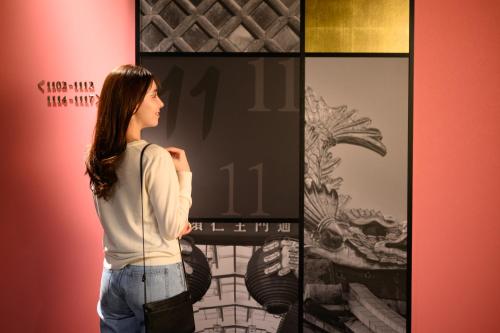 a woman looking at art on display in a store at The Royal Park Canvas Nagoya in Nagoya