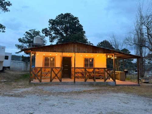 a large yellow building with a gate in front at Cabaña el Pino 1 in Creel