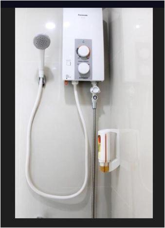 a blow dryer on a wall in a bathroom at Rana Hotel in Sampong