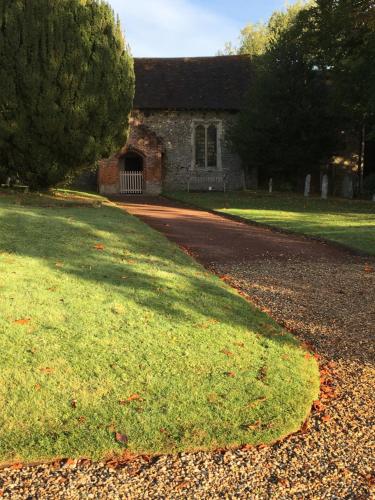 a stone house with a driveway in front of it at Sturmer Hall Hotel and Conference Centre in Haverhill