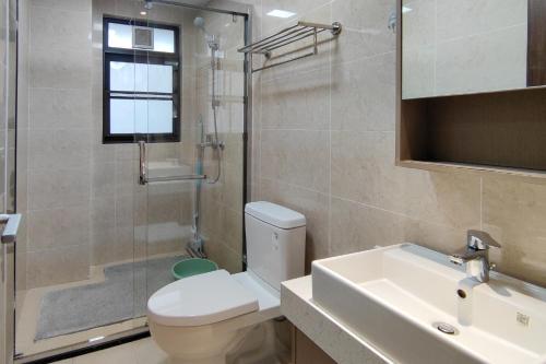 a bathroom with a toilet and a sink and a shower at WeChat user-s store in Gongche