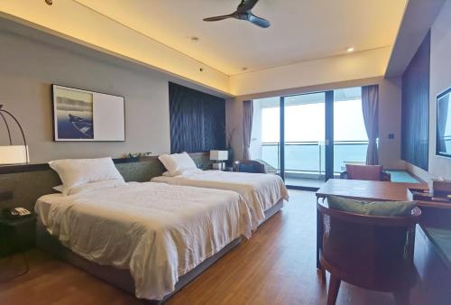 a hotel room with two beds and a balcony at Luke Cloud CTSE-s store in Gangkou