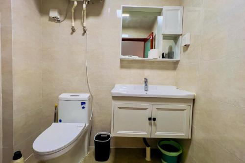 a bathroom with a toilet and a sink and a mirror at Luke Cloud RSJA-s store in Gongche