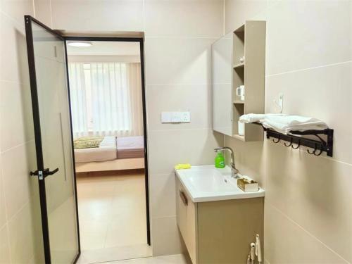 a bathroom with a shower and a sink and a mirror at Luke Cloud GSHT Store in Luoyang