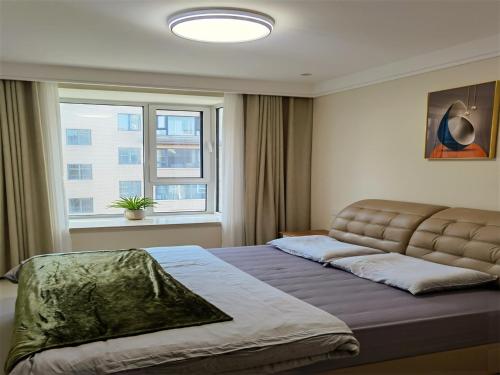 a bedroom with a bed and a large window at Luke Cloud GSHT Store in Luoyang