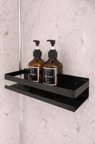 two bottles of soap on a shelf in a bathroom at Modern Guest house with private entrance in Manchester