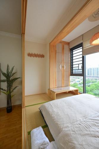 a bedroom with a large bed and a large window at Xia Jiming-s store in Ganzhou