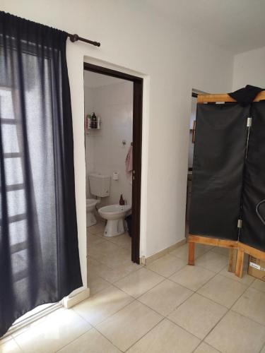 a bathroom with a toilet and a black shower curtain at mary in San Luis