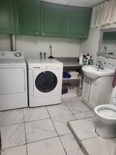 a kitchen with a washing machine and a sink at Full house close to everything in Sydney