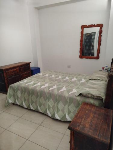 a bedroom with a bed and a table and a mirror at mary in San Luis