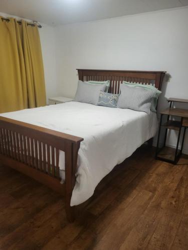 a bedroom with a large bed with white sheets and pillows at Full house close to everything in Sydney