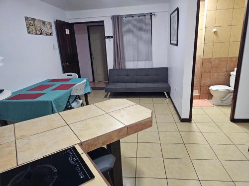 a living room with a table and a couch at Apartamento 2 TEC in Cartago