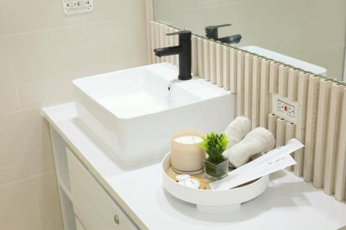 a white bathroom with a sink and a toilet at Azure Luxe Haven by Irene in San Fernando
