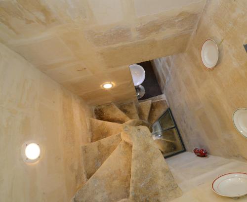 Habitación con pared de piedra y techo. en Paulos Valletta, en La Valeta