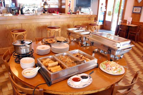 a table with food on it in a restaurant at Hôtel de l'ours in Vuiteboeuf