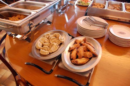 a counter with plates of food on a table at Hôtel de l'ours in Vuiteboeuf