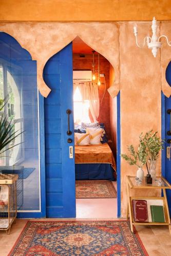 a bedroom with a blue door and a bed at Alter Space Workspace and CoLiving in General Luna