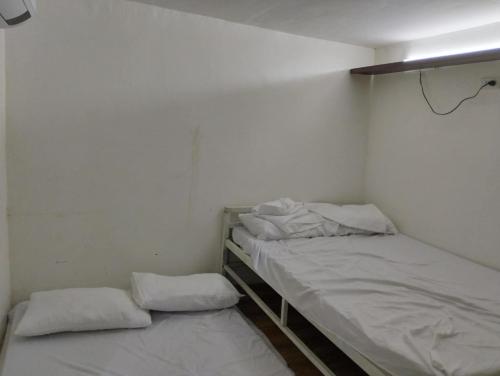 two beds in a small room with white walls at MGS viewdeck resort in Samal