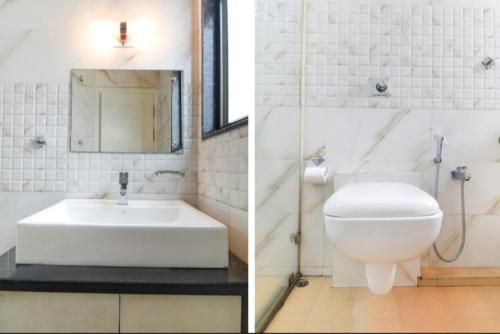 a white bathroom with a sink and a toilet at Hotel Holiday Palace in Sibsāgar