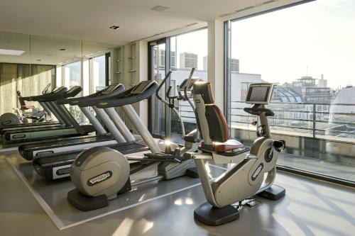 a gym with cardio equipment in a building at The Mandala Suites in Berlin