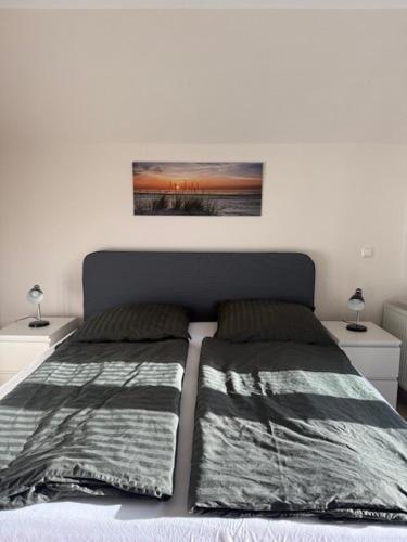 a bedroom with a bed with two night stands and two lamps at Haakestrasse 1j in Dahme