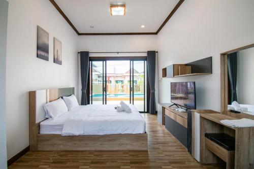 a bedroom with a bed and a large window at laboon pool villa Pranburi in Ban Nong Ban Kao