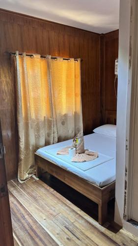 a small bed in a small room with at Port Barton - Paradiso Azul Campsite Beachfront with Internet in San Vicente