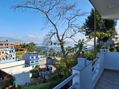 a view of the city from the balcony of a house at Mountain View Homestay in Tānsen