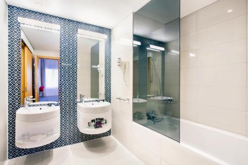 a bathroom with a sink and a mirror at Mercure Sohar in Sohar
