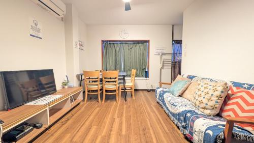 a living room with a couch and a table at 2min walk from the station Convenient for sightseeing in Tokyo Direct access to Shinjuku and Akihabara! Use of the Toei Shinjuku Line, 3-story house for rent in Tokyo