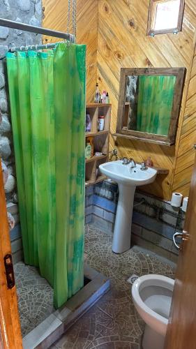 a bathroom with a shower curtain and a sink at La cabaña de Noe in San Clemente del Tuyú