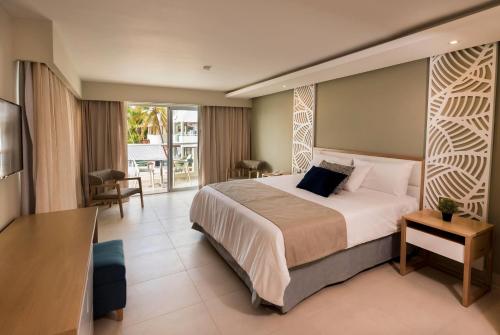ein Hotelzimmer mit Bett und Balkon in der Unterkunft Select Sosua Adults Only, Trademark by Wyndham All Inclusive in Sosúa