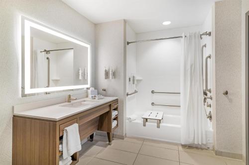 a bathroom with a sink and a shower and a tub at Home2 Suites by Hilton Queensbury Lake George in Queensbury
