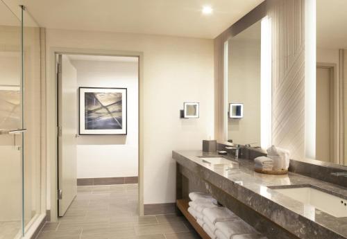 a bathroom with a sink and a mirror at Hyatt Regency Frisco-Dallas in Frisco