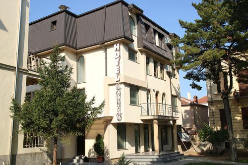 a large white building with a sign on it at Hotel Korzo in Bitola