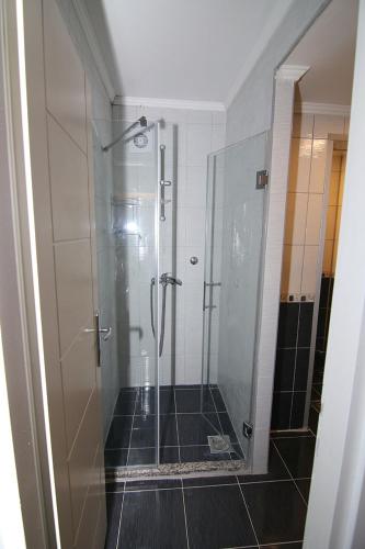 a shower with a glass door in a bathroom at Hotel Korzo in Bitola