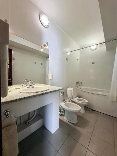 a bathroom with a sink and a toilet and a mirror at Nurtau in Pavlodar