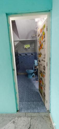 an open door to a bathroom with a toilet at Girivalam Nest in Jāmb