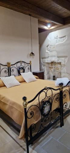 a bedroom with a large bed with a fireplace at Il Lentisco in Codrongianos