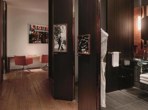 a bathroom with a mirror and a desk in a room at Andaz 5th Avenue, By Hyatt in New York