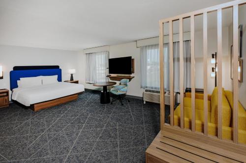 a hotel room with a bed and a desk at Hampton Inn & Suites by Hilton Tomball Houston NW in Tomball