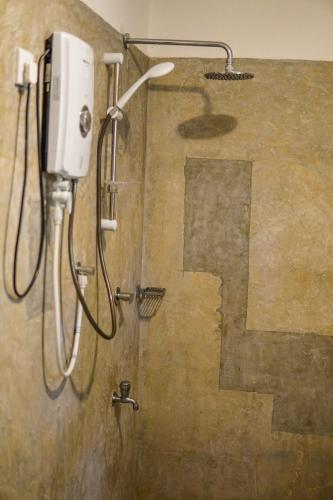 a shower in a bathroom with a shower head at Summit resort in Balangoda