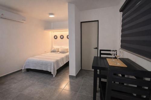 a bedroom with a bed and a table and a table sidx sidx sidx at Downtown, Comfortable Loft, in Hermosillo