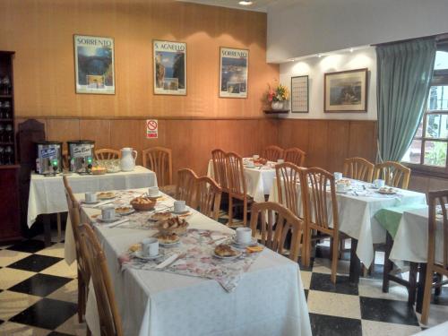 a dining room with tables and chairs with food on them at Hotel Mar in Mar del Plata