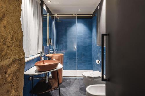a bathroom with a sink and a toilet and a shower at LOCANDA SANTAMARINA Dimora di Charme in Palermo