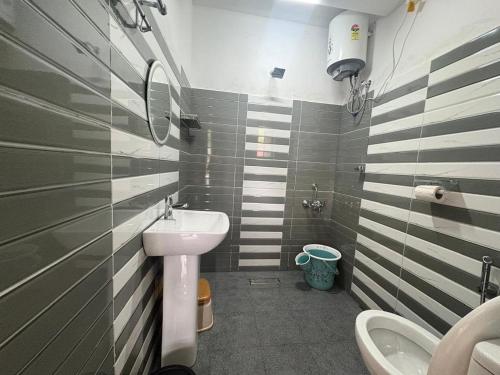 a small bathroom with a sink and a toilet at West corner B Homestay in Mawlynnong