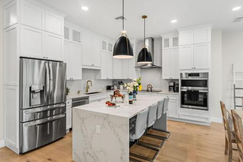 a kitchen with white cabinets and a large island at 40 8th Avenue in Indialantic