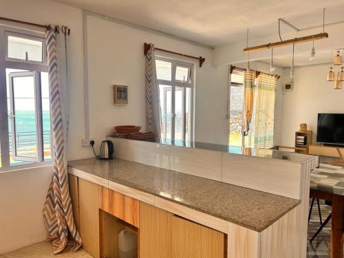 a kitchen with a large counter top in a room at EcoDream Lodge in Abercrombie
