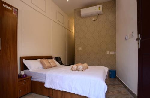 a bedroom with two beds with a dog laying on the bed at Cloud valley wayanad in Vayittiri