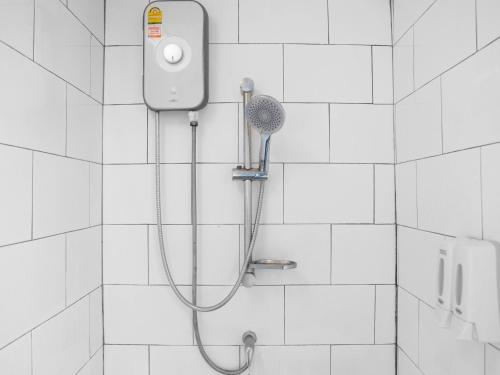 a shower with a shower head on a wall at serene hotel in Chiang Mai